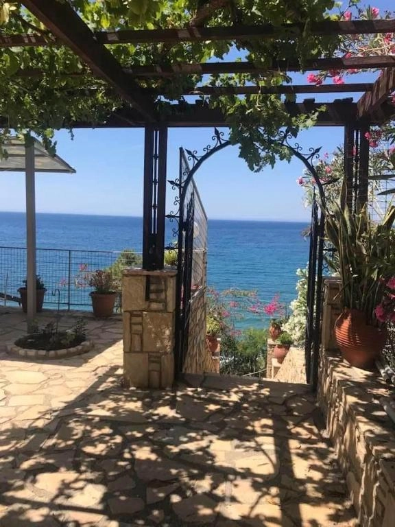 Garden gate opening to the sea